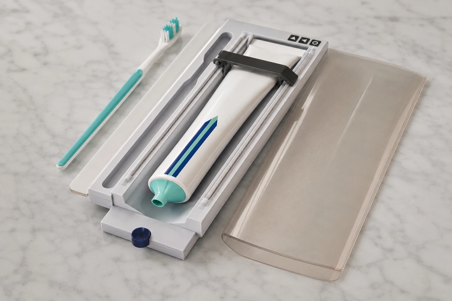 The Pearl case open, showing a toothbrush and toothpaste together with the one-touch dispenser that presses out a clean line of paste